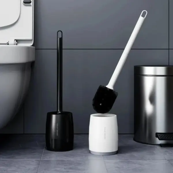 Brosse WC noire et brosse toilette blanche dans un WC moderne.