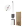 Brosse WC suspendue en silicone avec support, design moderne et pratique pour salle de bain.