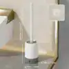 Brosse WC avec support mural, design moderne, couleur blanche et gris, dimensions indiquées.